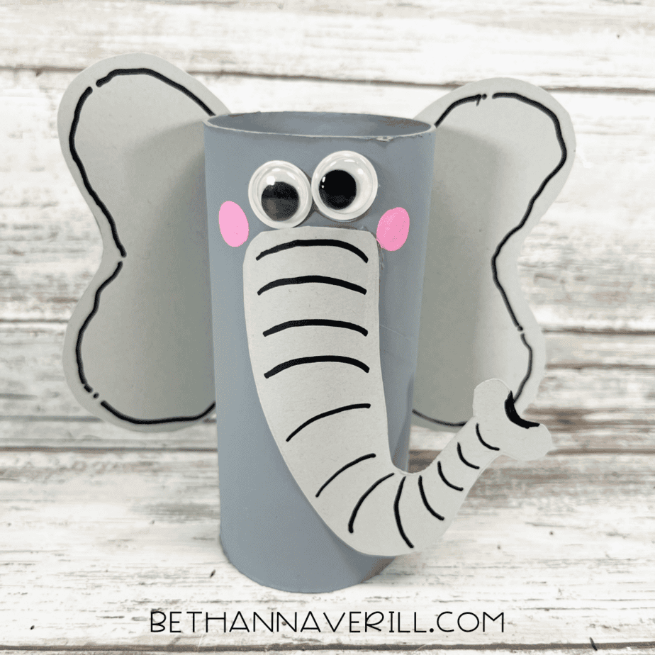Finished elephant paper roll craft with googly eyes, pink cheeks, and outlined ears.