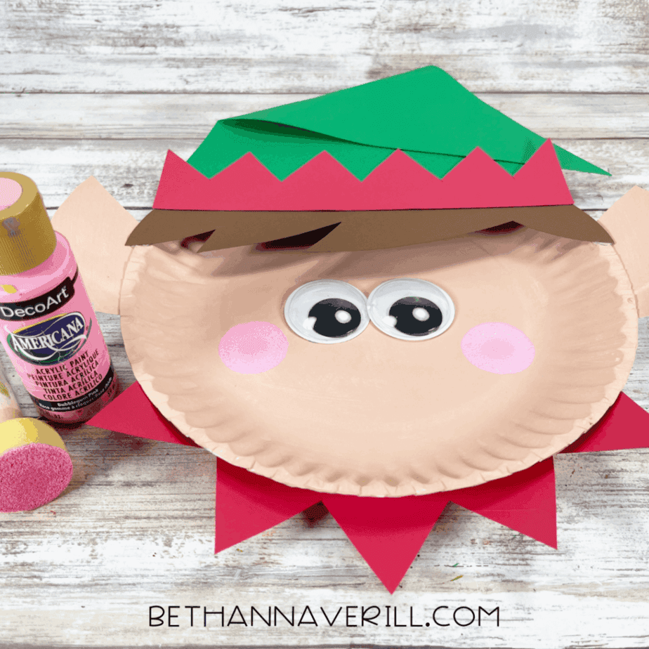 Pink cheeks painted on elf face with sponge dabber.