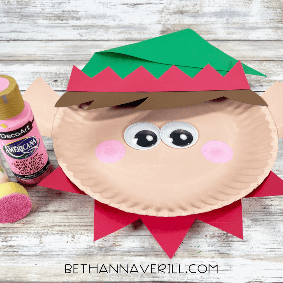 Pink cheeks painted on elf face with sponge dabber.