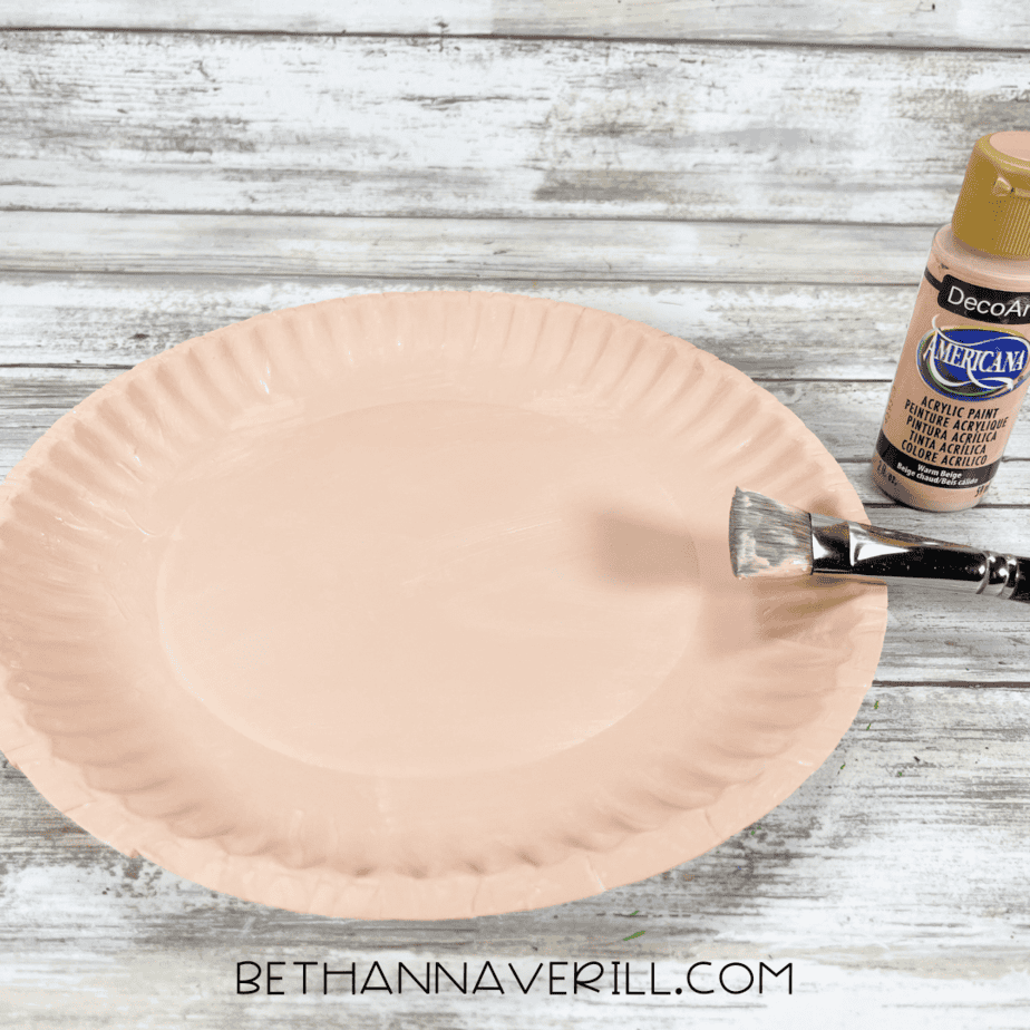 tan painted paper plate