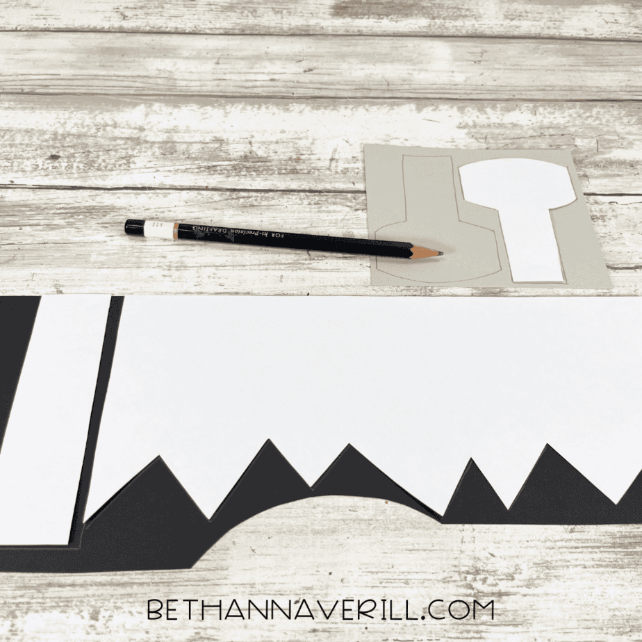 Paper templates traced on black and gray paper for Frankenstein’s hair and bolts.