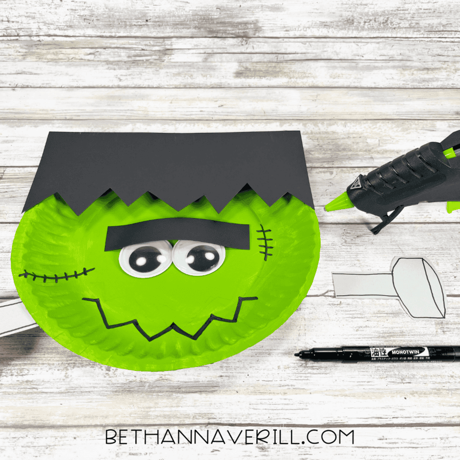 Frankenstein plate with eyebrows and googly eyes, gray paper bolts ready to attach.