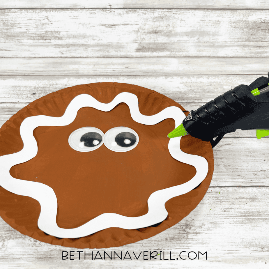 Googly eyes glued onto the gingerbread paper plate.