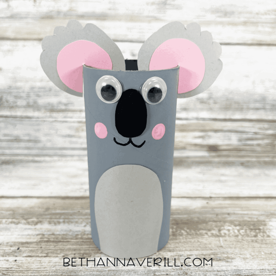 Finished koala paper roll craft with gray body, pink ears, googly eyes, and painted cheeks.