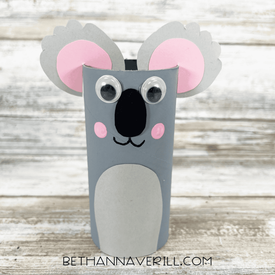 Finished koala paper roll craft with gray body, pink ears, googly eyes, and painted cheeks.