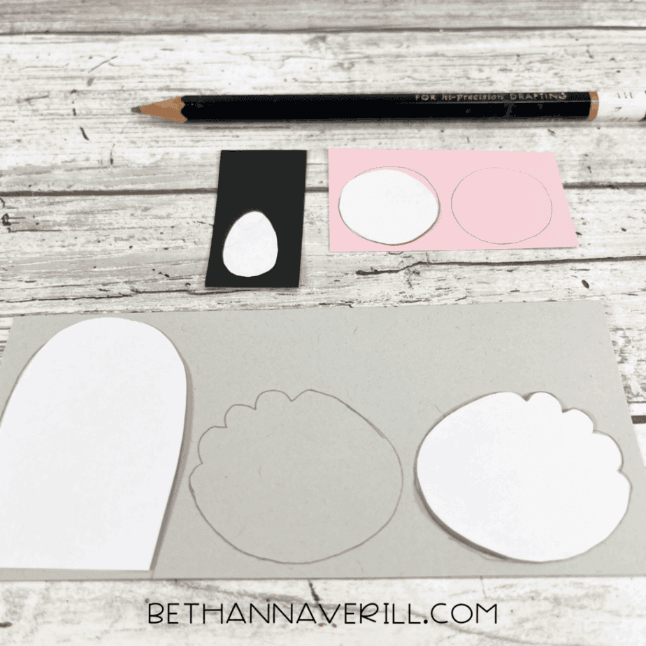 Koala ear, belly, and nose templates traced onto gray, pink, and black paper with a pencil.