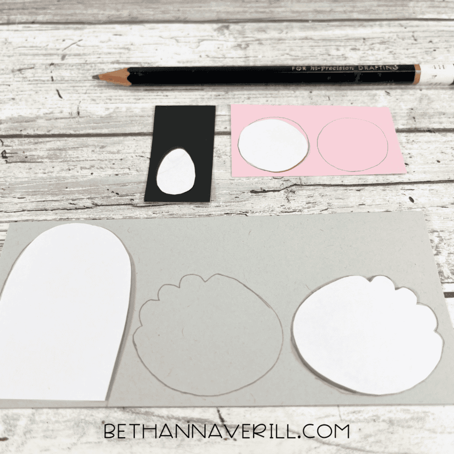 Koala ear, belly, and nose templates traced onto gray, pink, and black paper with a pencil.