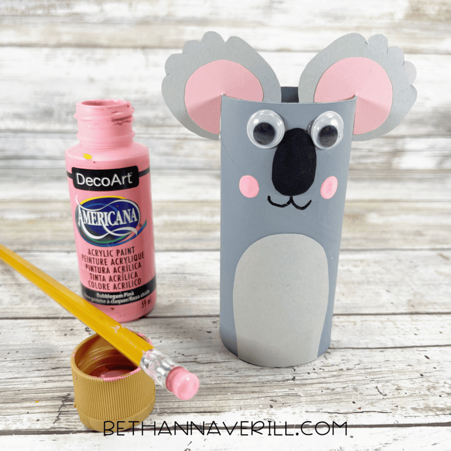 Koala paper roll with pink painted cheeks added beside a bottle of pink paint and pencil.
