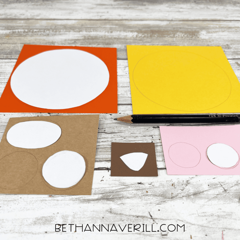 Circle templates traced on colored construction paper for lion craft.
