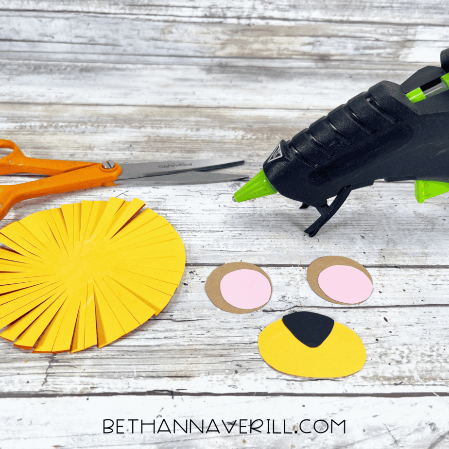 Yellow oval face and fringed mane ready to assemble for lion craft.