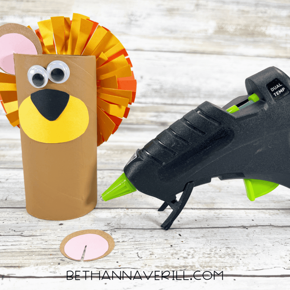 Lion paper roll with mane, googly eyes, and ears attached.