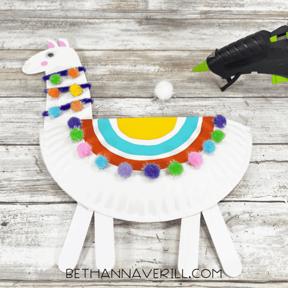 Llama head glued to the top of the decorated paper plate body