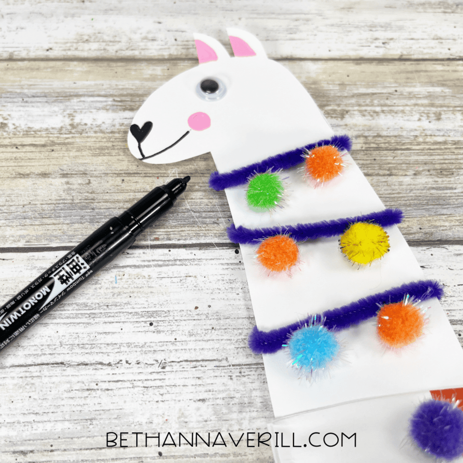 A close-up of the llama head with a marker used to draw the mouth and nose details.