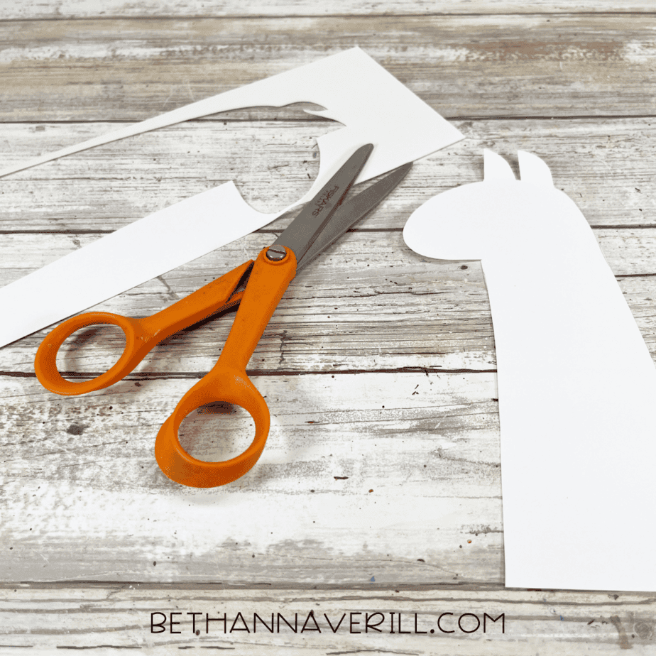 The llama head cut out of the cardstock with scissors beside it.
