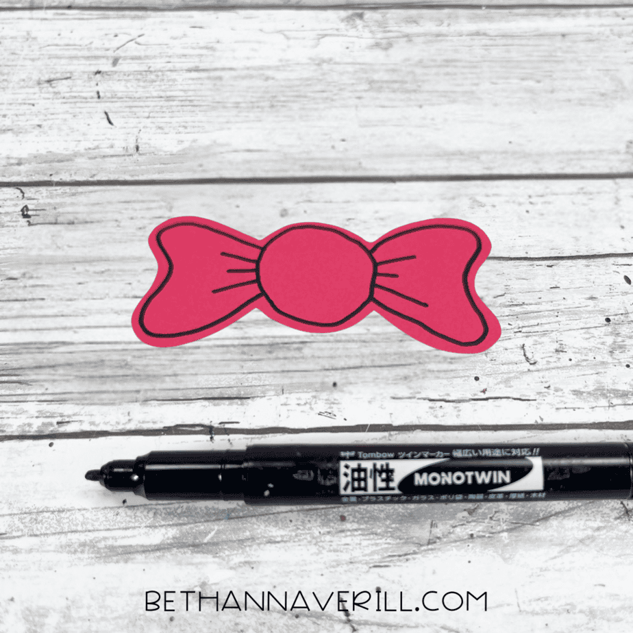 Red bow with black marker details drawn on it.