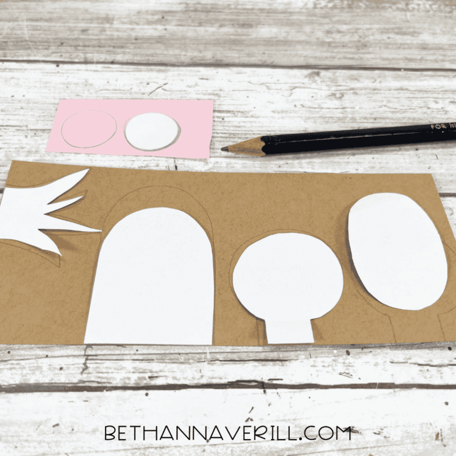 Monkey craft template pieces traced onto brown and pink construction paper.