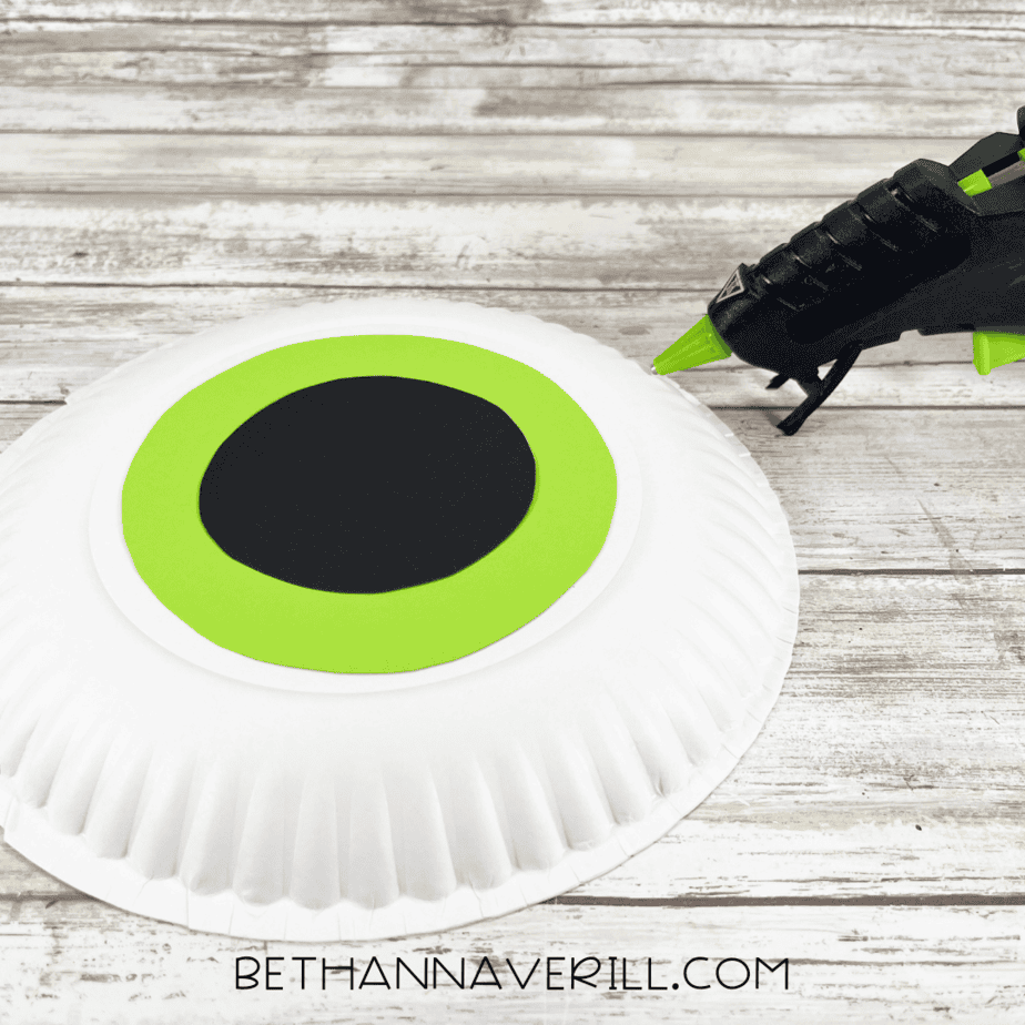 Black circle glued on top of the green circle to make the pupil of the monster eye.