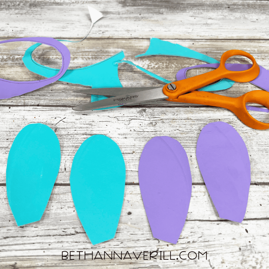 Flipper and fin shapes cut from aqua and purple plates.