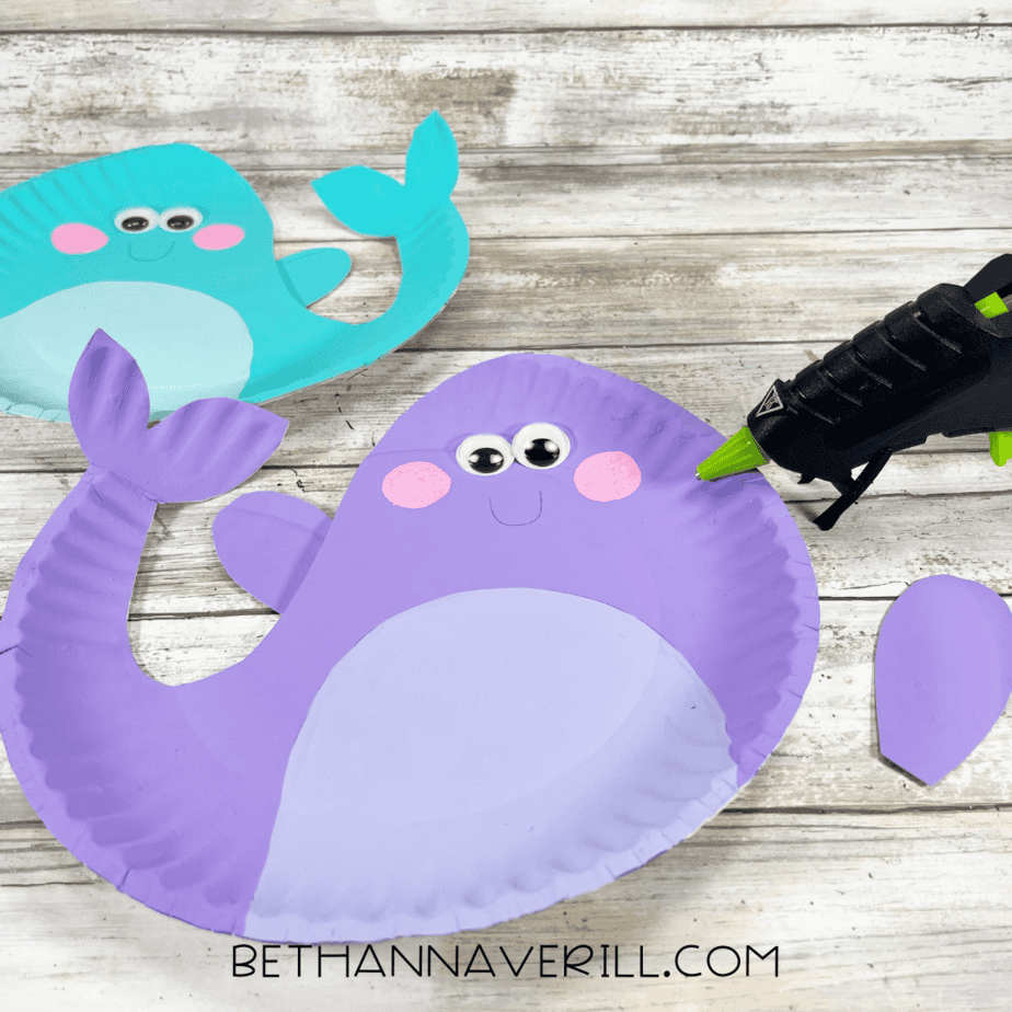 Purple narwhal with glued-on eyes and cheeks.