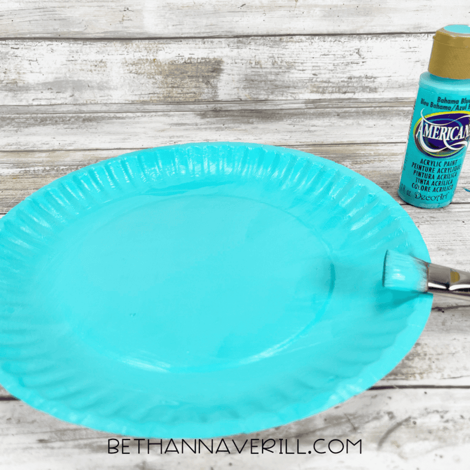 Paper plate painted aqua for narwhal body.