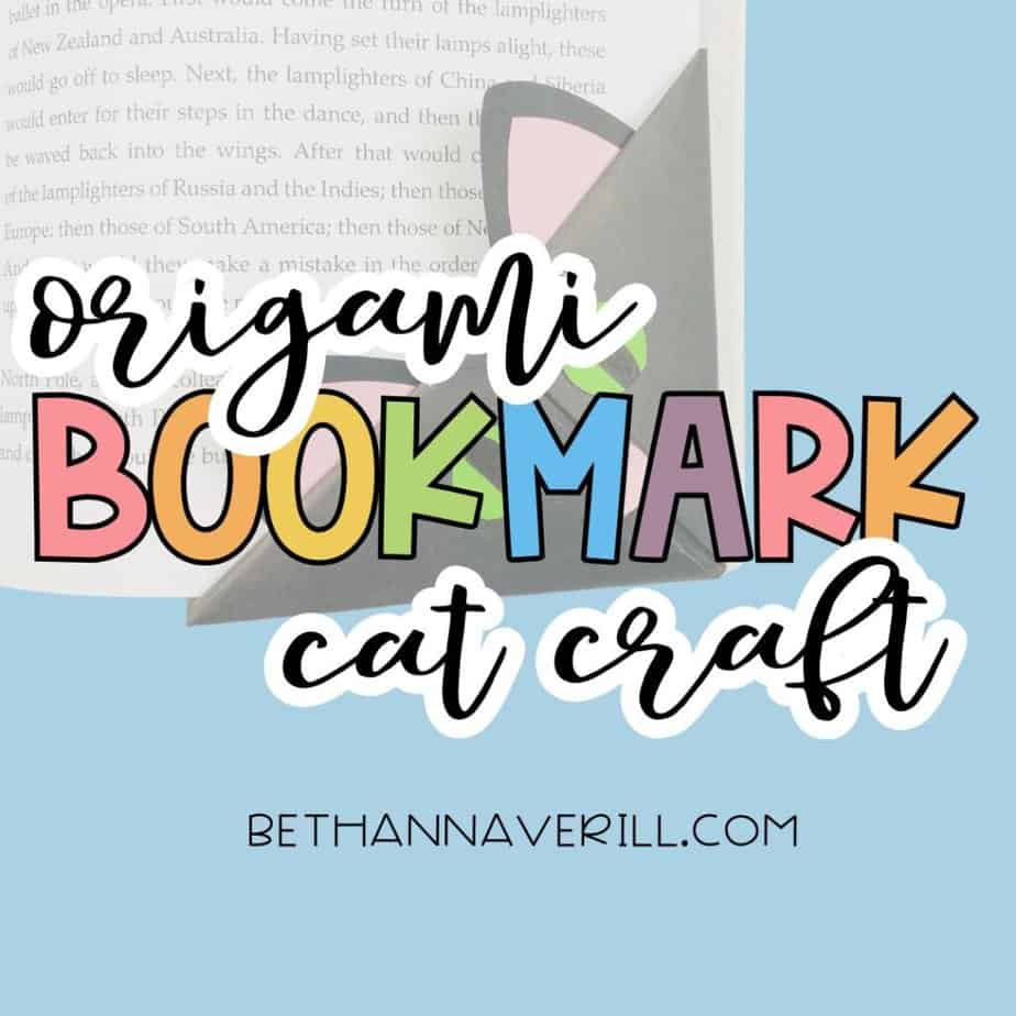 “Origami Bookmark Cat Craft” appears in colorful text over a photo of a handmade cat-shaped paper bookmark tucked into a book. Promotes a simple DIY reading-themed craft for kids.