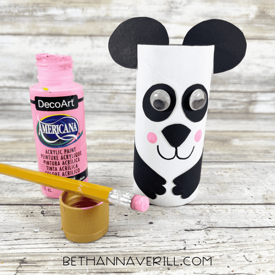 Adding pink painted cheeks with a pencil eraser to the panda’s face.