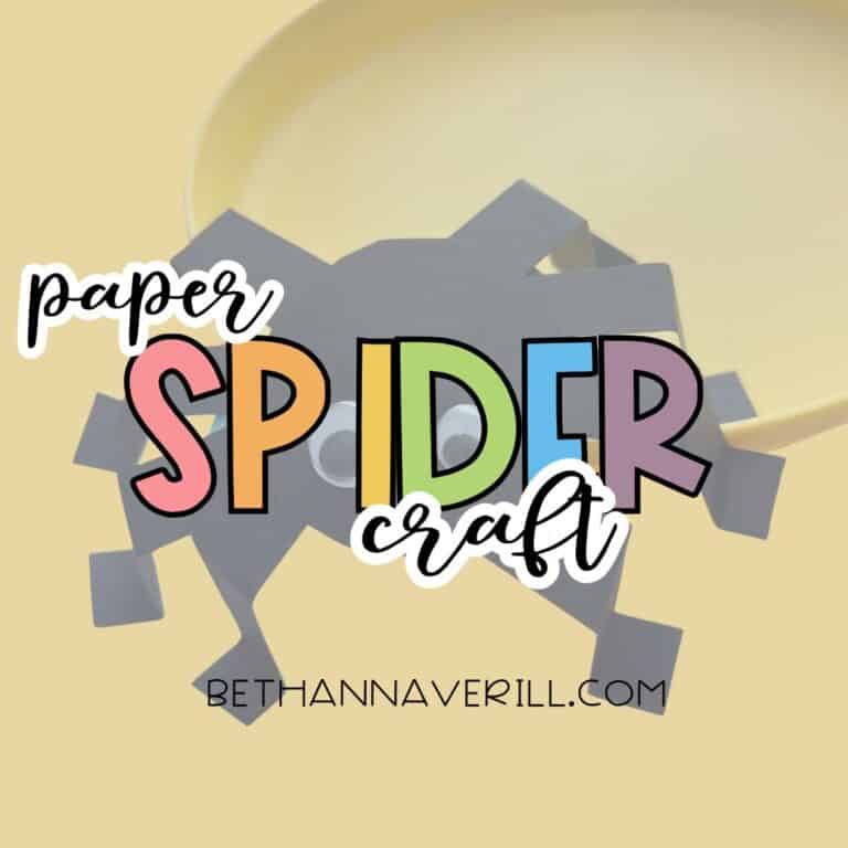 “Paper Spider Craft” overlays an image of a black spider made from paper with googly eyes, set on a light yellow background. Promotes a spooky Halloween-themed activity for kids.