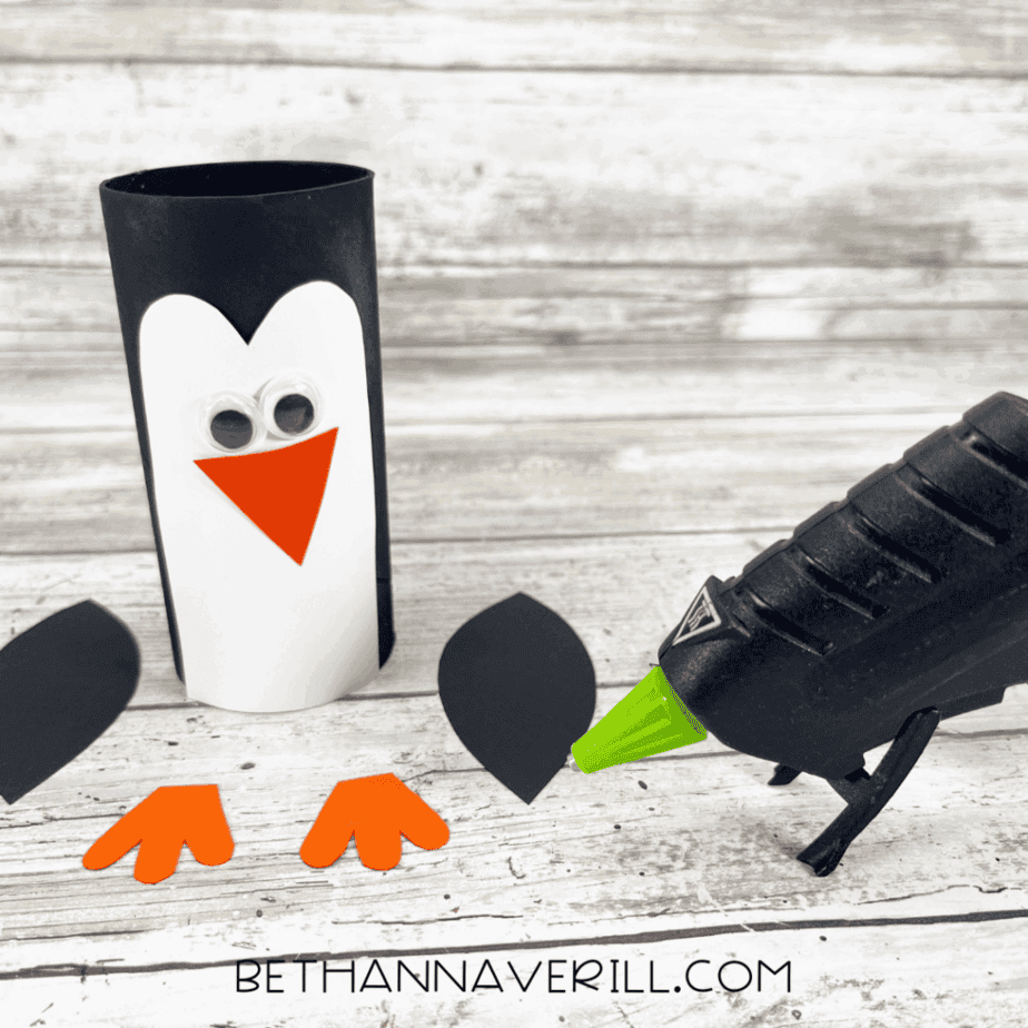 Penguin paper roll with belly and googly eyes glued on, beak ready to attach.