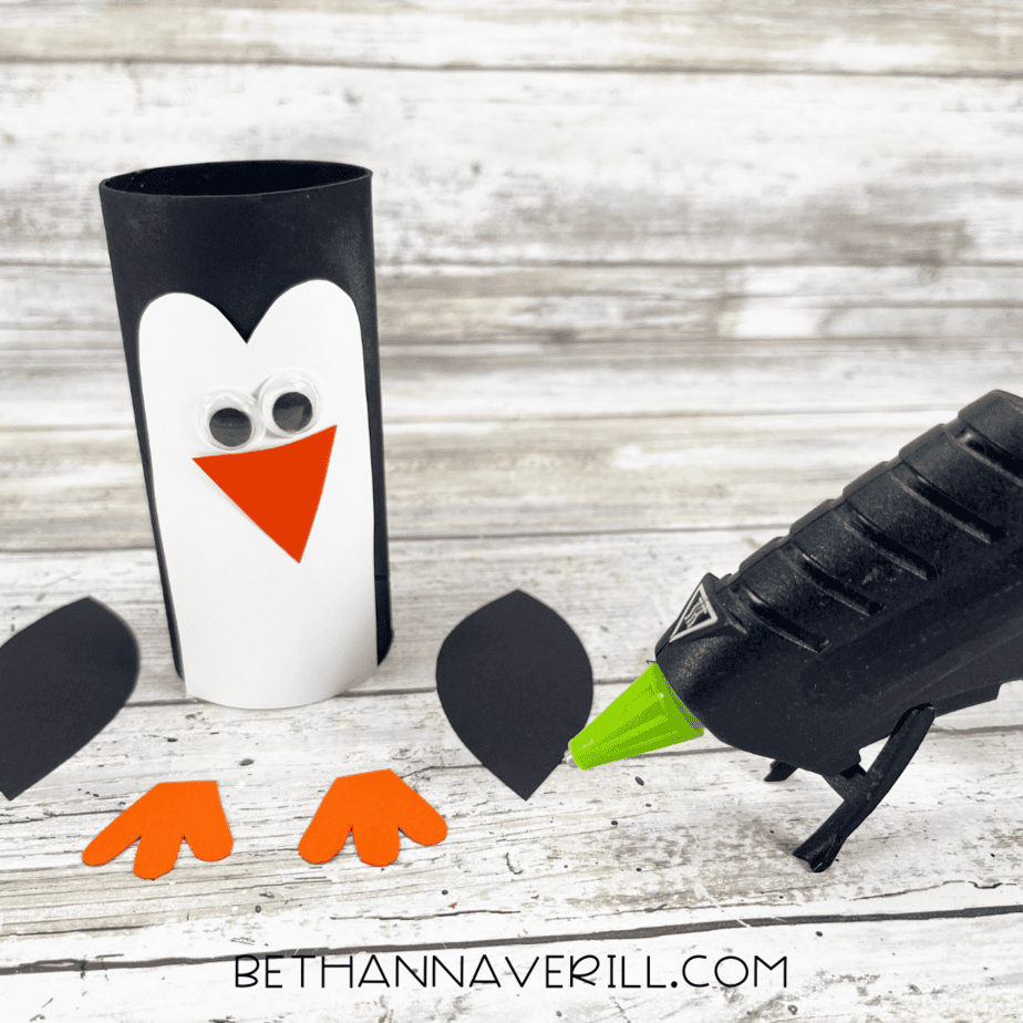 Penguin paper roll with belly and googly eyes glued on, beak ready to attach.
