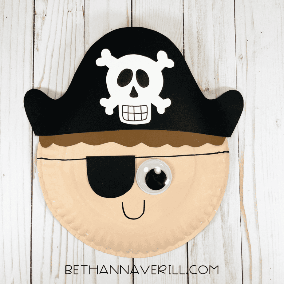 Finished pirate boy paper plate craft with black hat, skull and crossbones, and big googly eye.