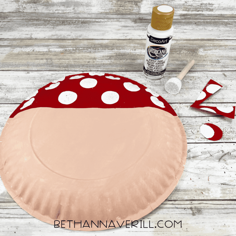 White polka dots painted on the red bandana with sponge brush.