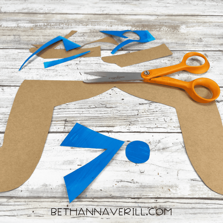 Cut-out pirate hair and blue bandana tie pieces with scissors.