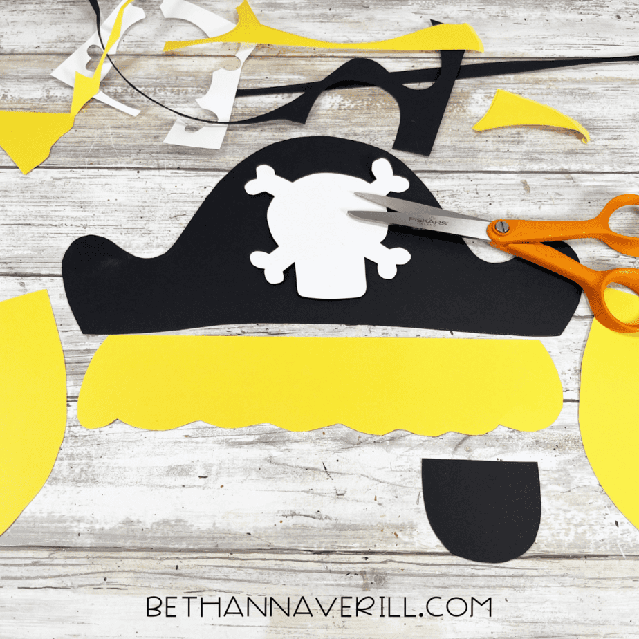 Pirate hat, hair, and skull pieces cut out from construction paper.