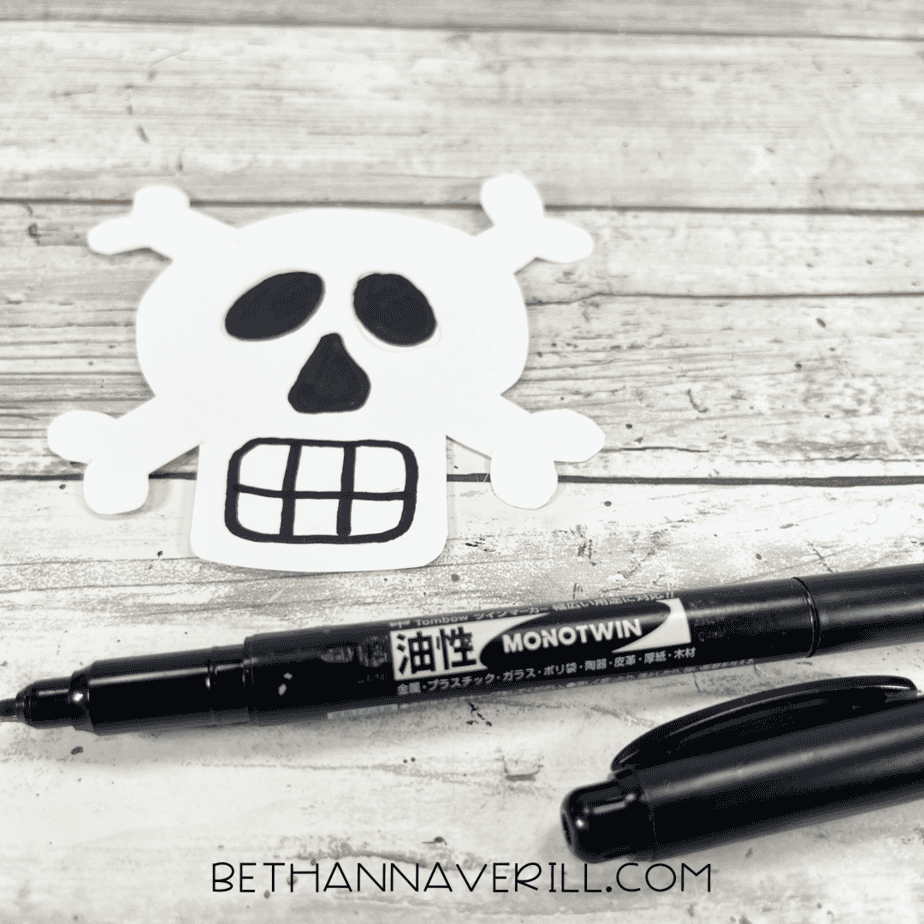 White skull and crossbones drawn with black details for pirate hat.