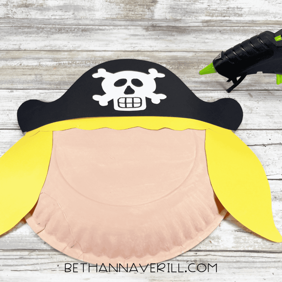 Pirate hat and yellow paper hair glued onto the paper plate face.