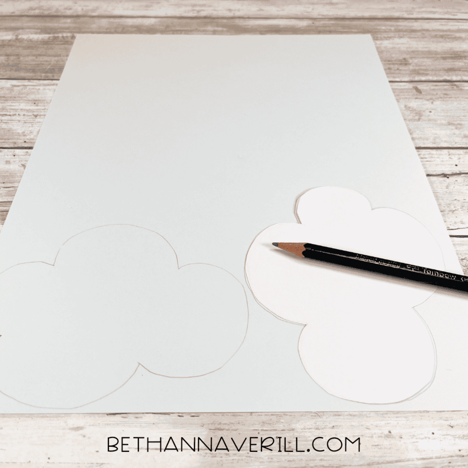 Cloud shapes drawn on white cardstock with a pencil.