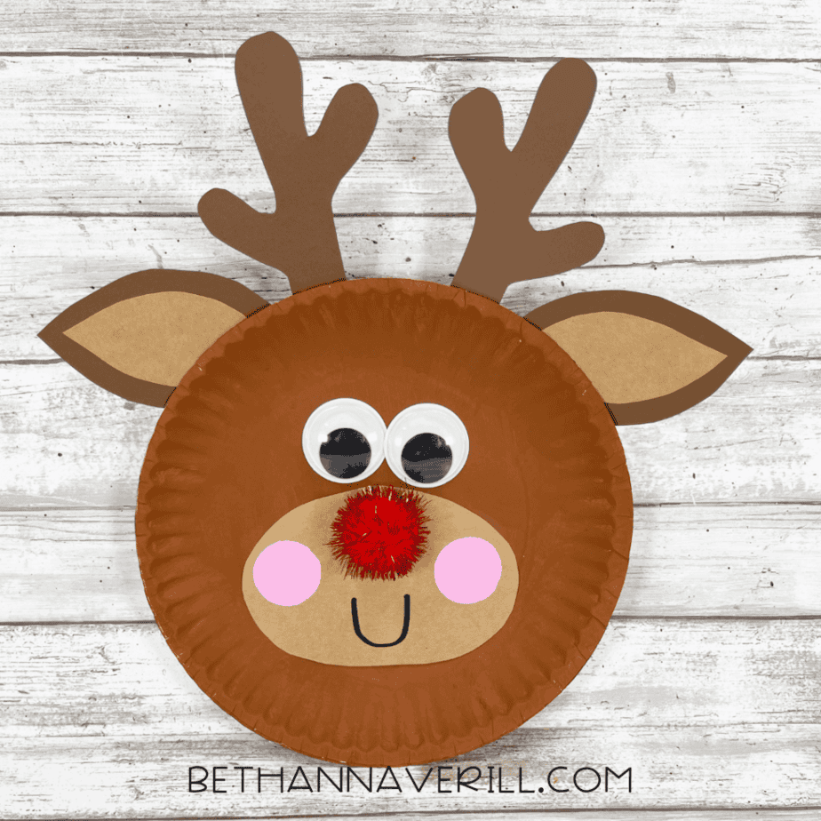 Finished Rudolph reindeer paper plate craft with antlers, ears, red nose, googly eyes, and smile.