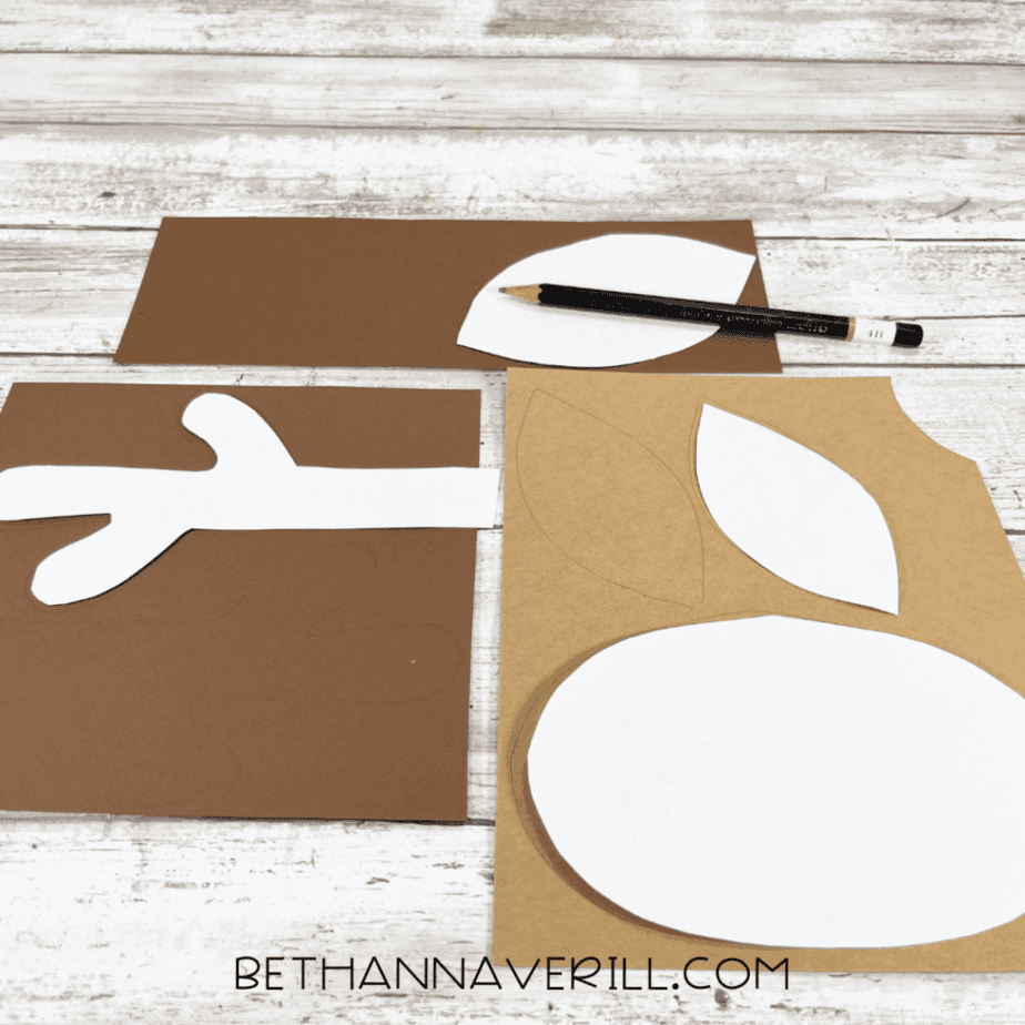 Templates traced onto brown and tan construction paper for antlers, ears, and muzzle.