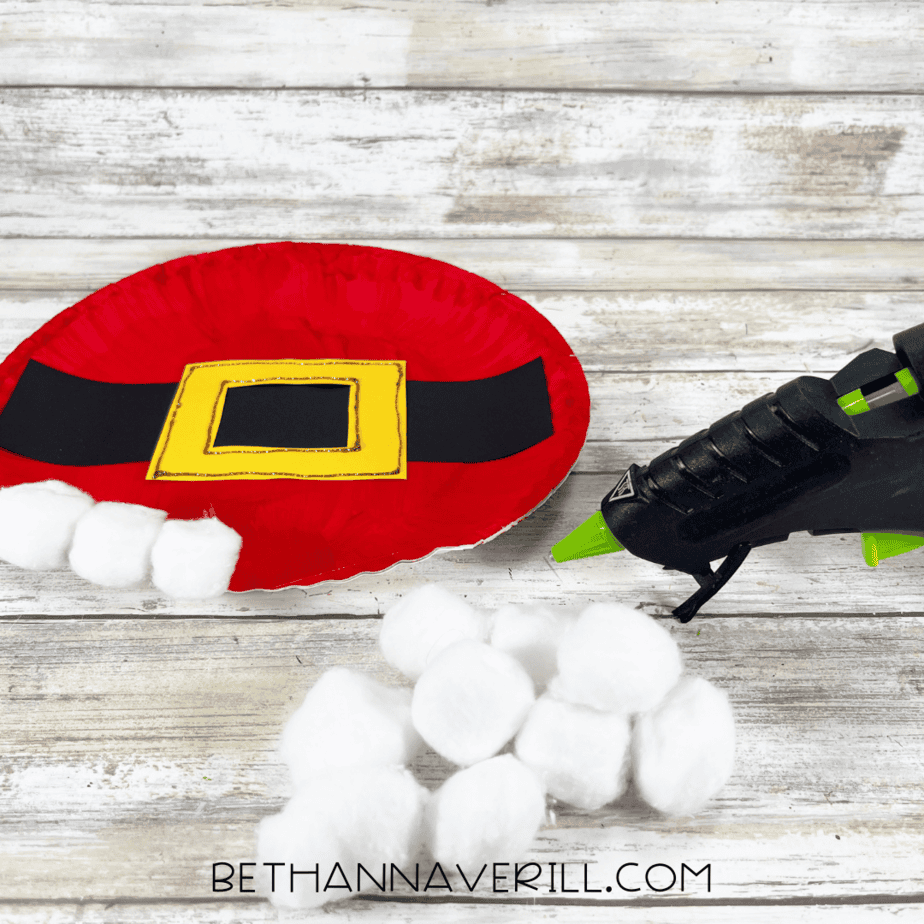 Cotton balls glued to bottom edge of Santa belt plate.