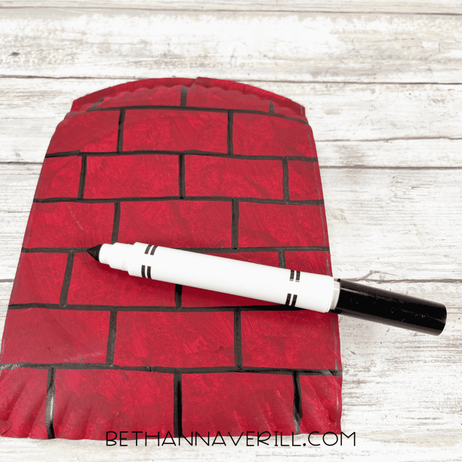 Red plate with black marker brick lines drawn to look like a chimney.