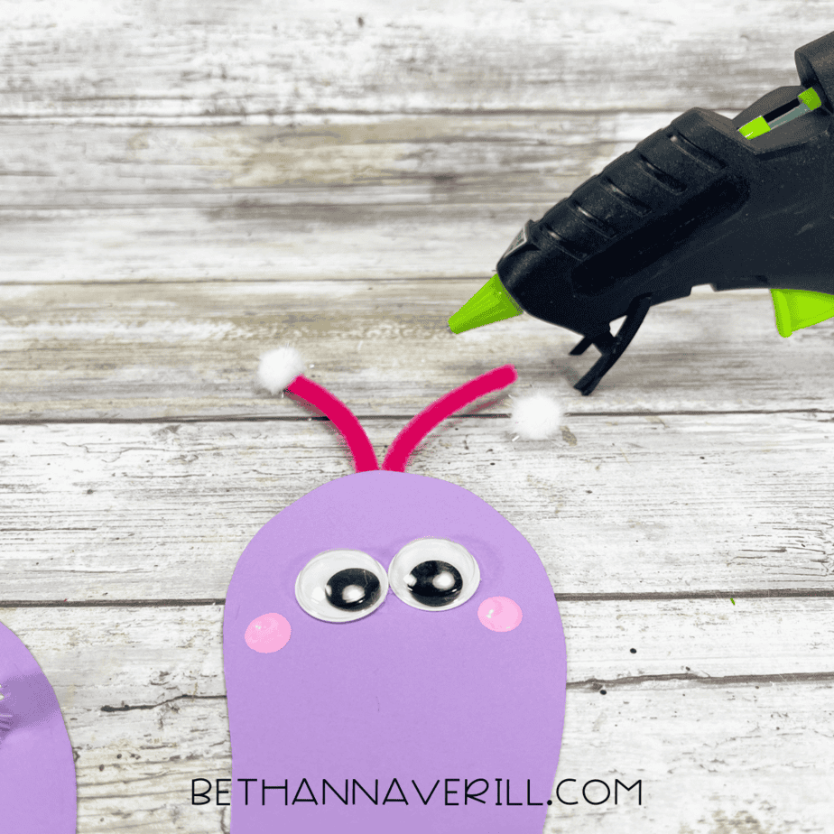 Red pipe cleaners with white pom poms glued to snail’s head as antennae.