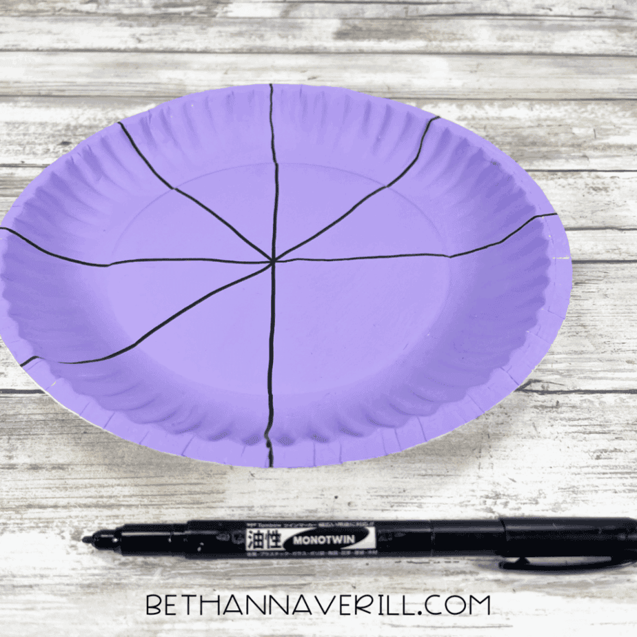 Purple plate with straight black lines drawn from the center to the edges.