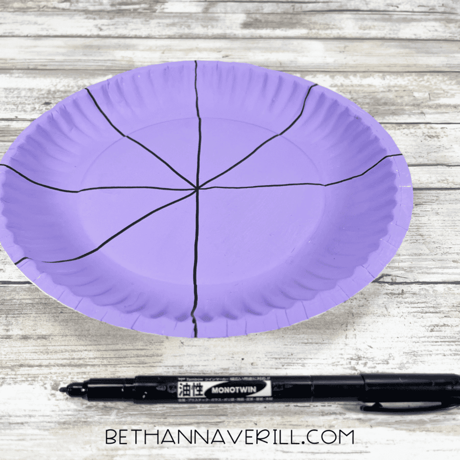 Purple plate with straight black lines drawn from the center to the edges.