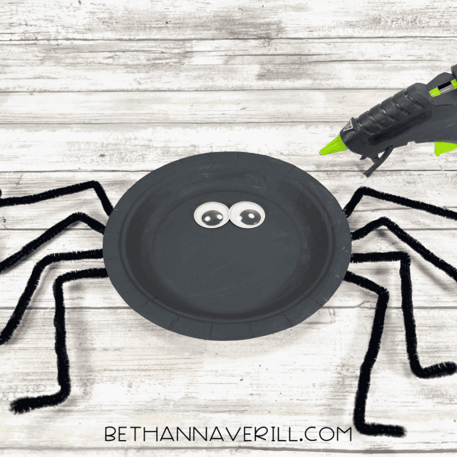 Googly eyes glued onto the black spider plate.