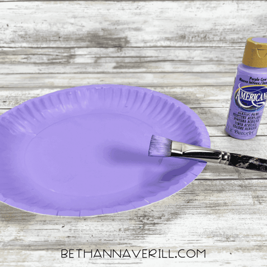 Purple paper plate painted with a brush.