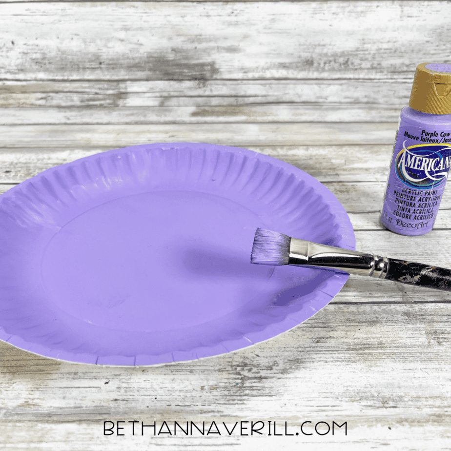 Purple paper plate painted with a brush.