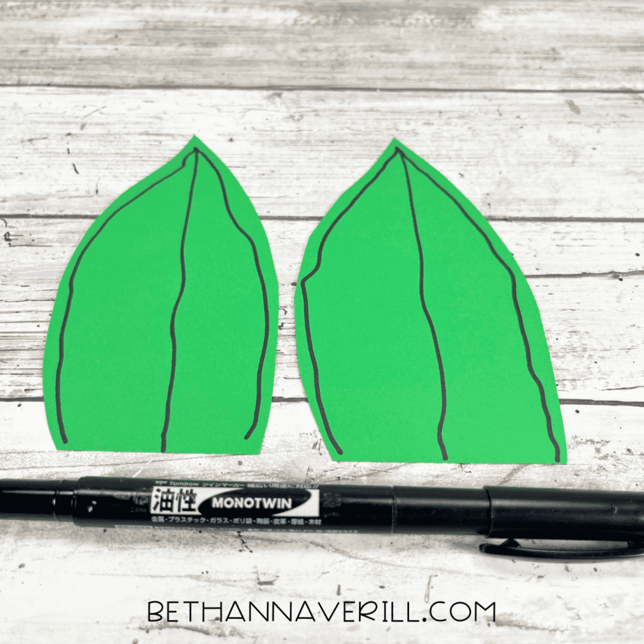 Green leaves decorated with black marker vein lines.