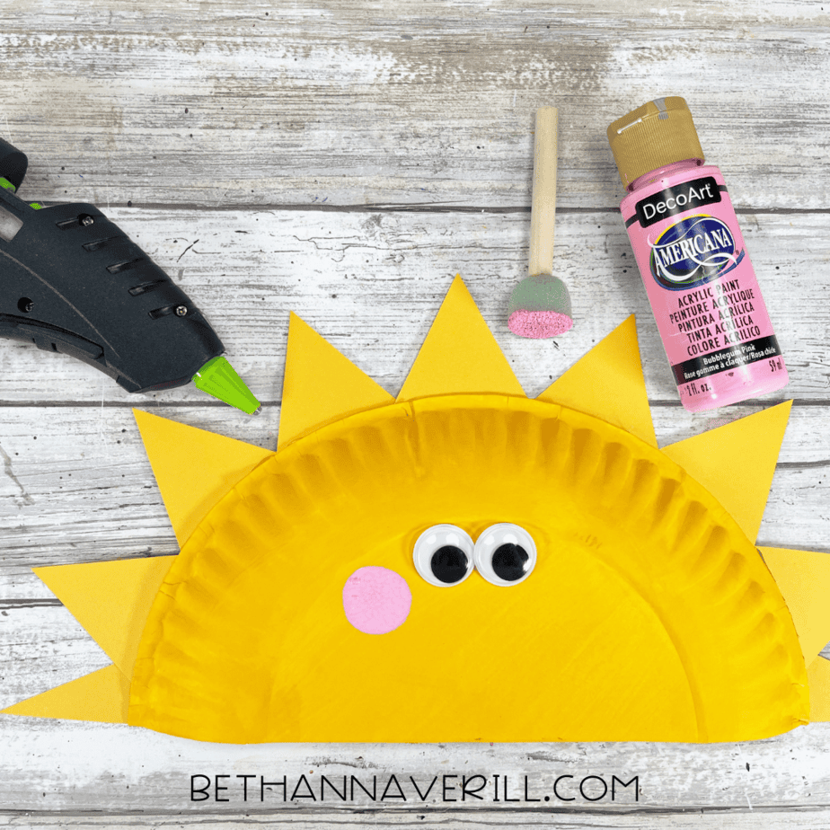 Sunshine craft with googly eyes glued on and pink cheeks added using paint.