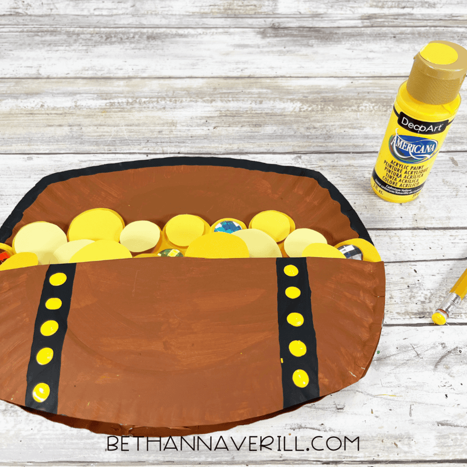 Treasure chest with yellow studs painted on black bands.