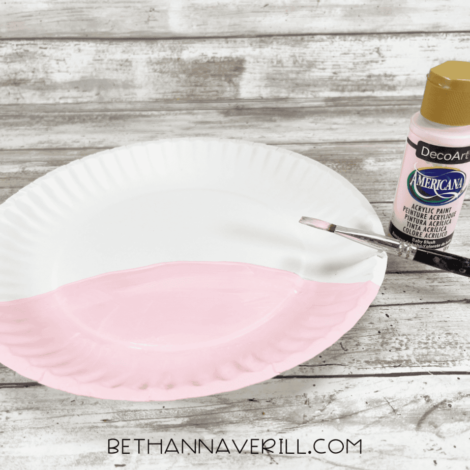 Paper plate half-painted pink with pink acrylic paint for the unicorn’s snout.
